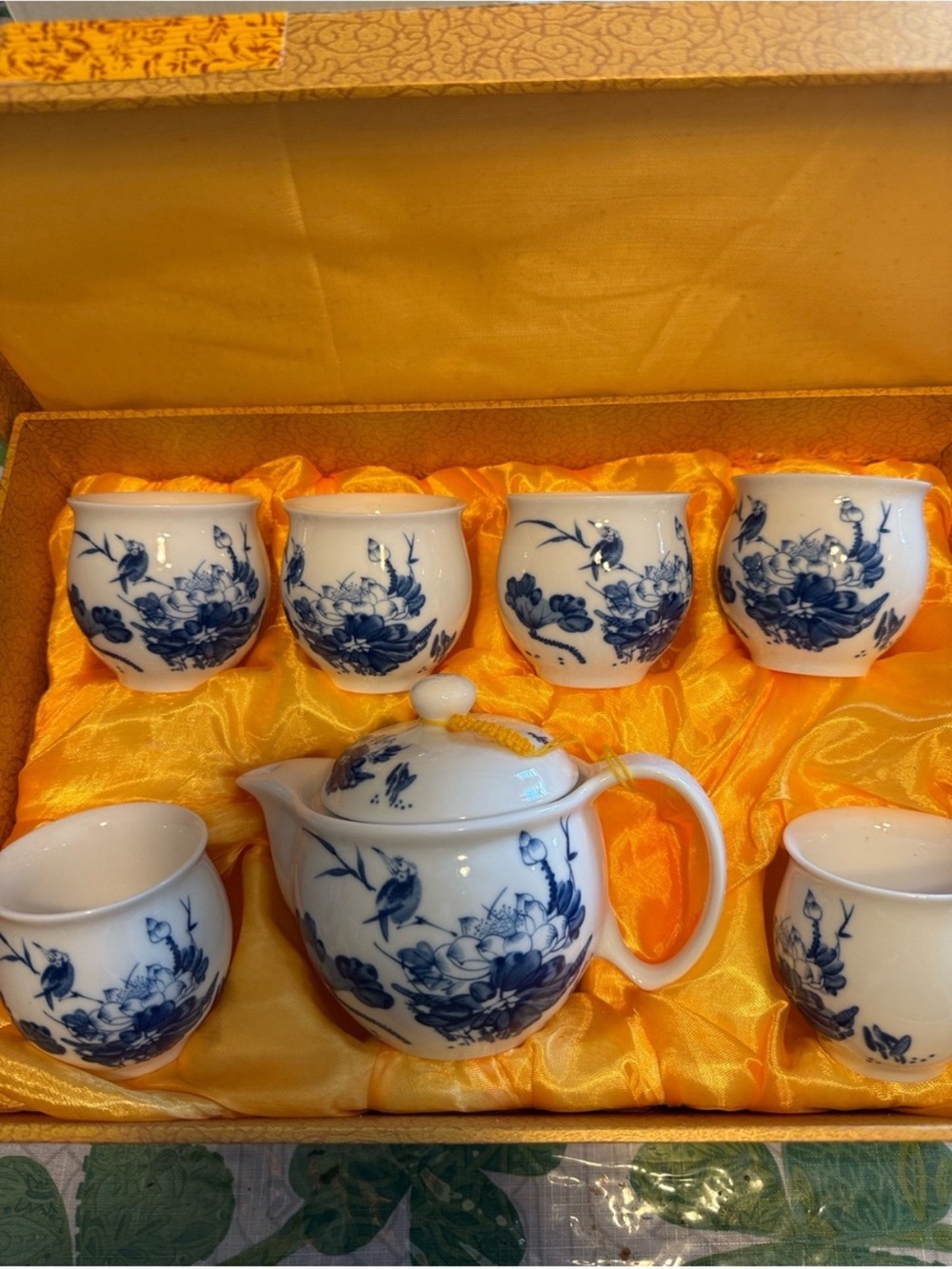 Chinese porcelain tea set featuring blue and white floral designs.